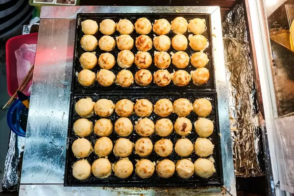 Flat lay of takoyaki balls on food tray (Flip 2019)