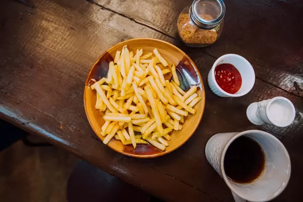 Flat lay shot of fries and coffee