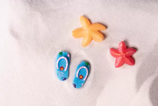 Flip flops and sea stars on the sandy beach