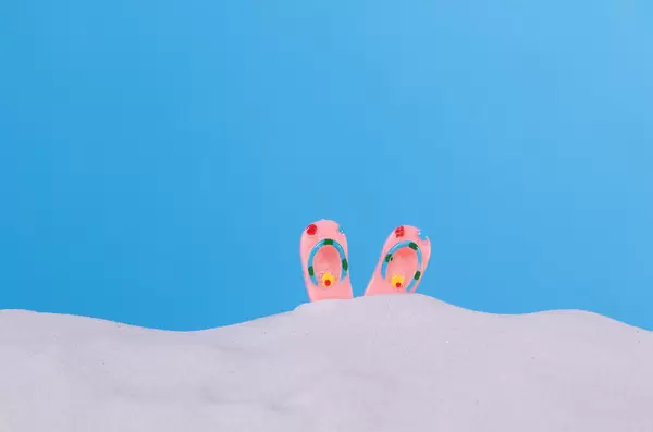 Flip flops on a beach sand