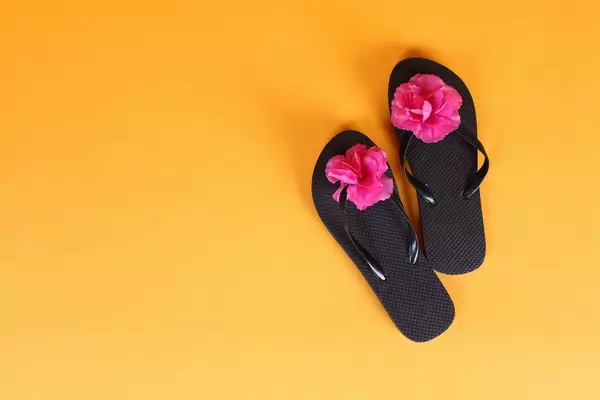 Flip Flops with flowers on orange background