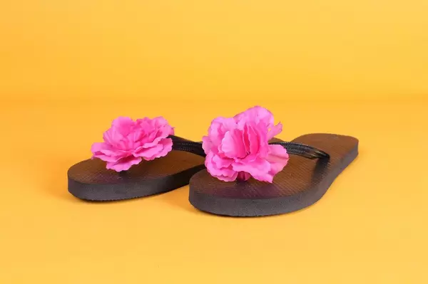 Flip Flops with pink flowers on orange background
