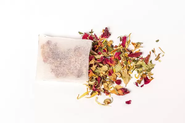 Floral green tea with tea bag, top view