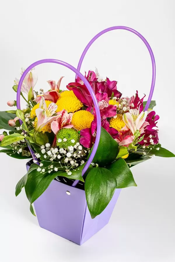 Flower arrangement in a gift box on white