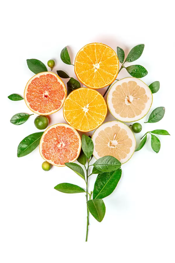 Flower made with ripe orange, sweetie, grapefruit and calamondina on white