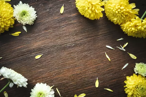 Flowers making a frame on wood