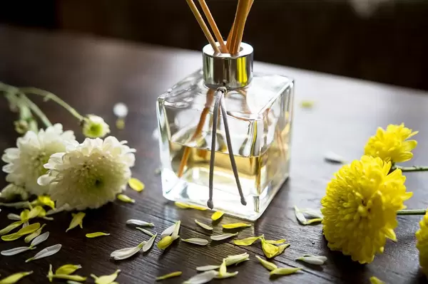 Flowers scent - close up of an aromatic glass bottle with flowers