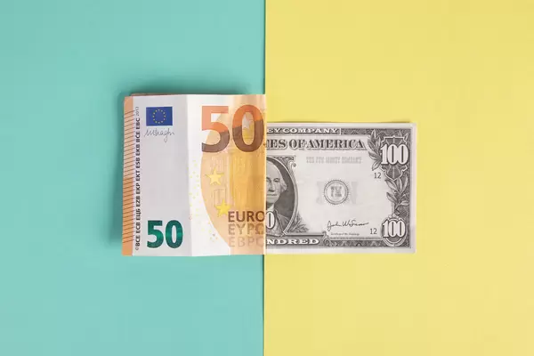 Folded 50 Euro and 100 Dollar banknotes