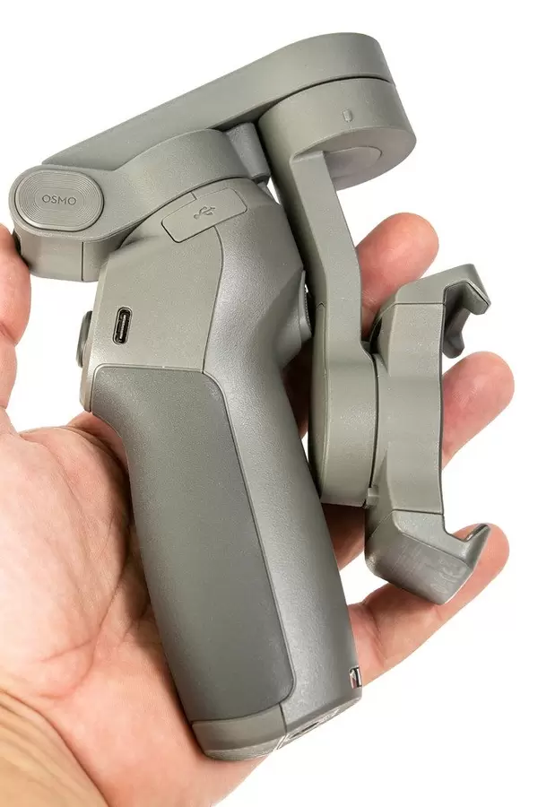 Folded DJI Osmo Mobile 3 phone gimbal in the hand
