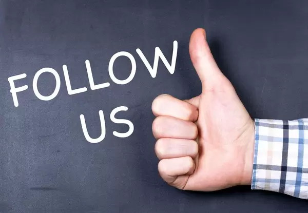 Follow us text with hand showing thumbs up
