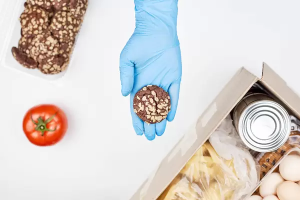 Foodbank volunteer giving a sweet cookie