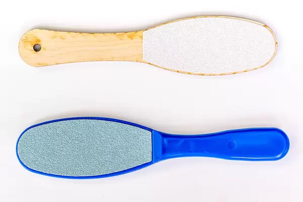 Foot skin care accessories on white