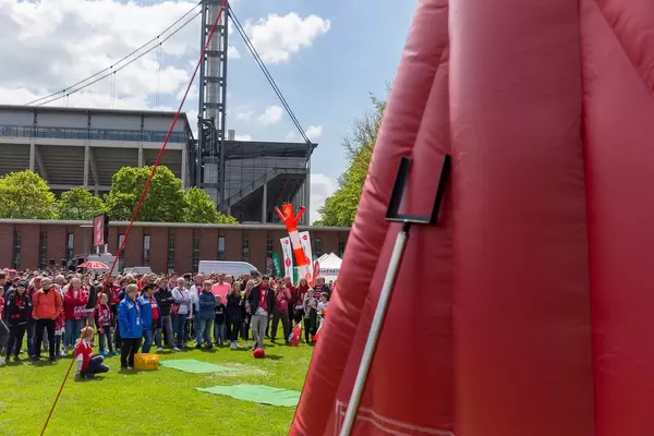 Football fans of the football team 1. FC Köln shoot footballs with Velcro at a gigantic target after the finals in front of Rhein Energie Stadium in Cologne