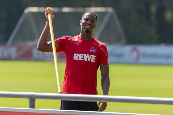 Football player Kingsley Ehizibue enjoys minutes after the training and smiles on the pitch at Geißbockheim, Cologne
