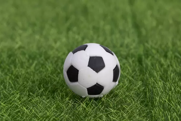 Football soccer ball on grass field