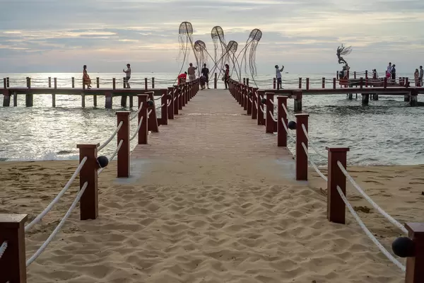 Footbridge at Sunset Sanato Beach Club with many Photo Ideas and People taking Pictures with Sun Reflection in the Sea