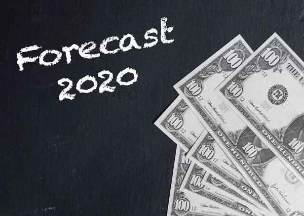 Forecast 2020 text with US dollar banknotes