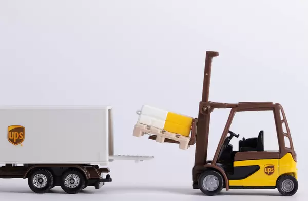 Forklift loading pallet into the UPS truck