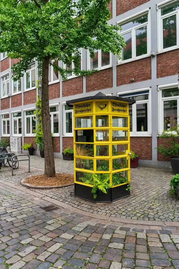 Former telephone booth in city center of Bremen, Germany repurposed as greenhouse for plants