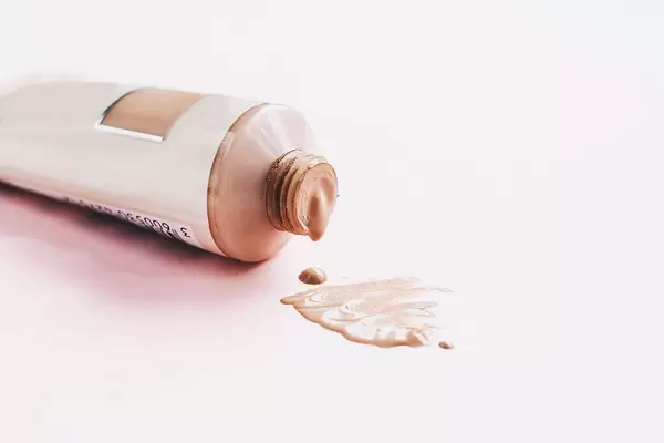 Foundation make up spilling out of a bottle