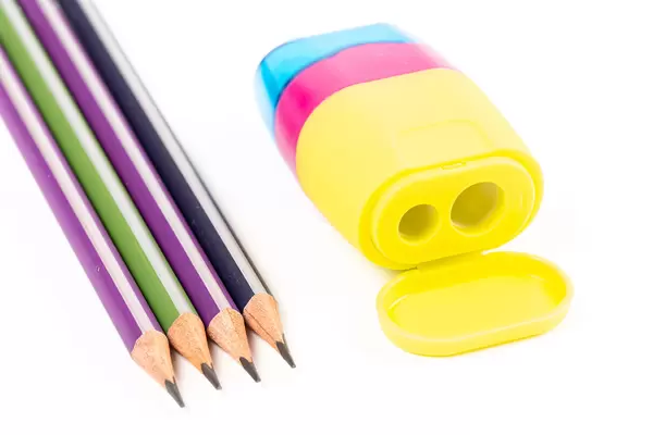 Four pencils and a multi-colored sharpener