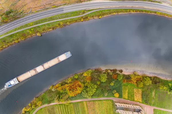 Frachtschiff mit Sand beladen auf dem Fluss Mosel entlang der Bundesstraße B49 mit Kloster Stuben in Bremm, Deutschland Vogelperspektive