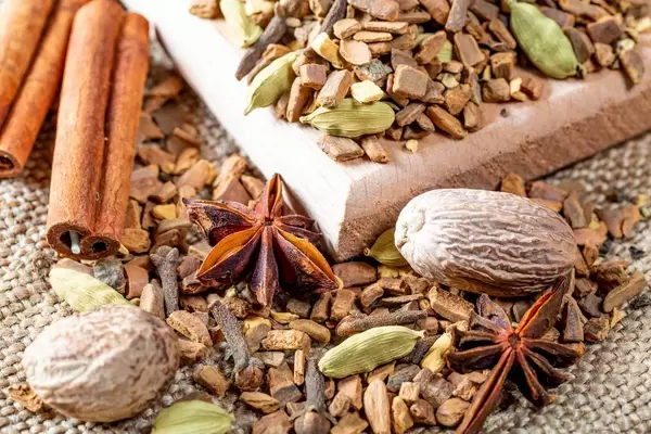 Fragrant dry tea from bark, spices, and roots on burlap