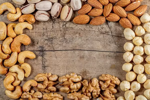 Frame-made-of-different-nuts-on-an-old-wooden-background-with-free-space-top-view.jpg