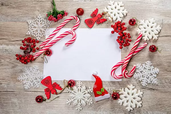 Frame of Christmas decor and white snowflakes on wooden background with free space (Flip 2019)