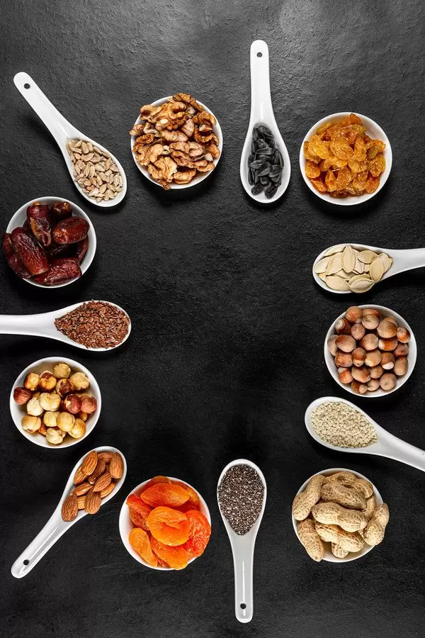 Frame of healthy food products-dried fruits, nuts and seeds, top view (Flip 2020)