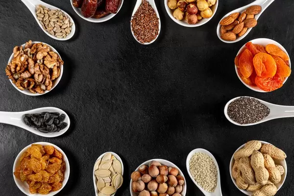 Frame-of-nuts-dried-fruits-and-seeds-on-a-black-background-with-free-space.jpg