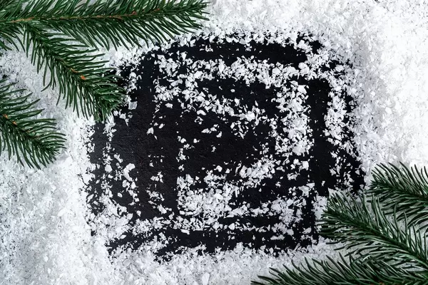 Frame of snow and Christmas tree branches with free space