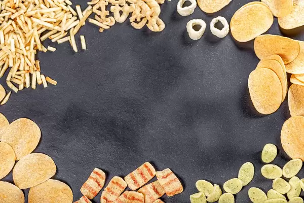 Frame with a variety of beer snacks on a black background. Top view (Flip 2019)