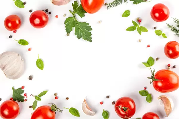 Frame with fresh cherry tomatoes with herbs and spices, top view
