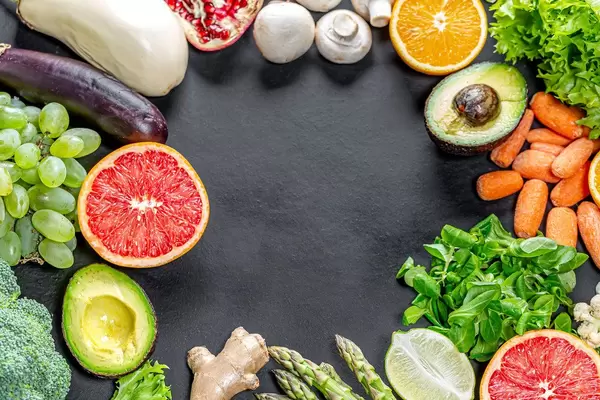 Frame with fresh healthy products on black background