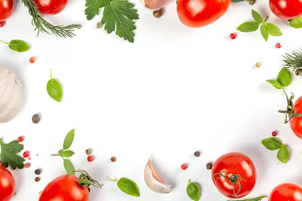 Frame with fresh herbs, tomatoes, garlic and spices on white, free space