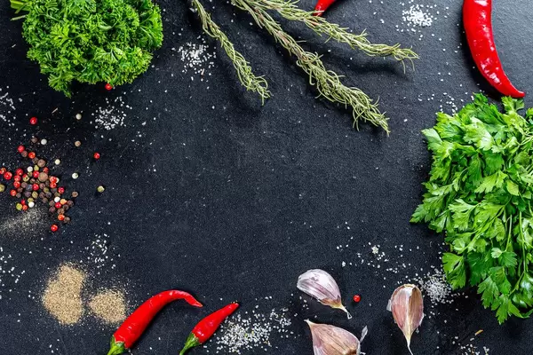 Frame with spices and herbs on black background. Top view (Flip 2019)