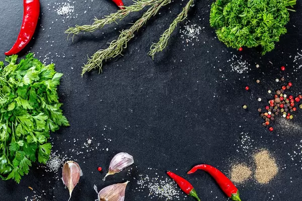 Frame with spices and herbs on black background. Top view