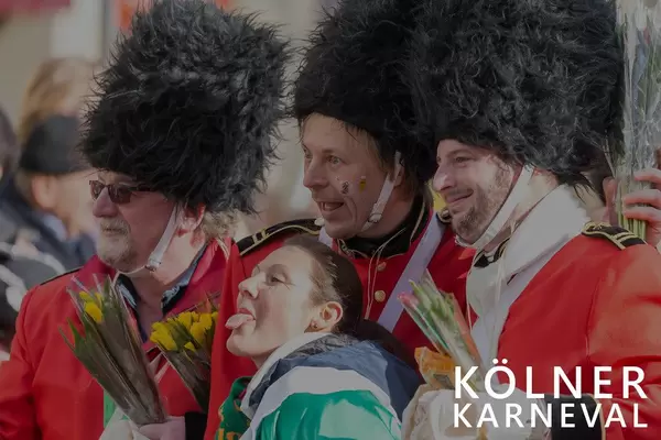 Frau macht ein Foto mit drei Gardisten während des Kölner Karneval