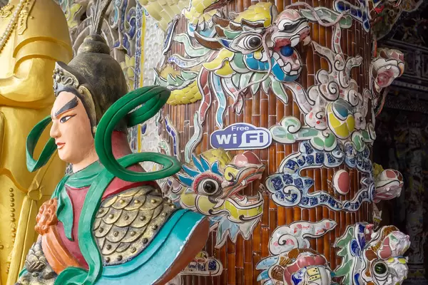 Free WiFi Sign next to Dragons and Ornaments inside a Pagoda in Da Lat, Vietnam