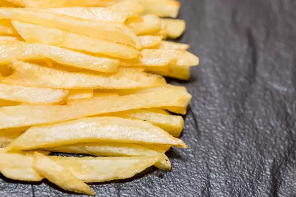 French fries on black background