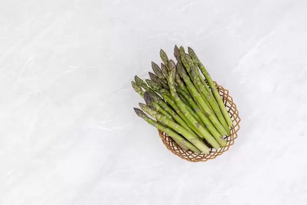 Fresh Asparagus in the woven basket