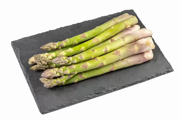 Fresh Asparagus on the black stone tray