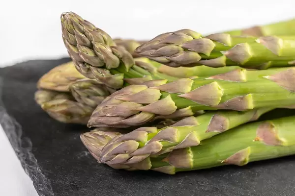Fresh Asparagus on the black tray
