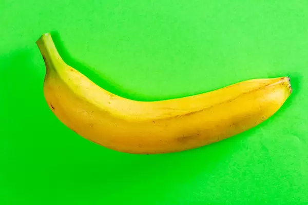 Fresh banana on green background. Top view (Flip 2019)