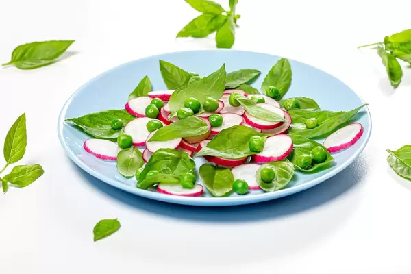 Fresh Basil leaves and radishes on a blue plate (Flip 2019)