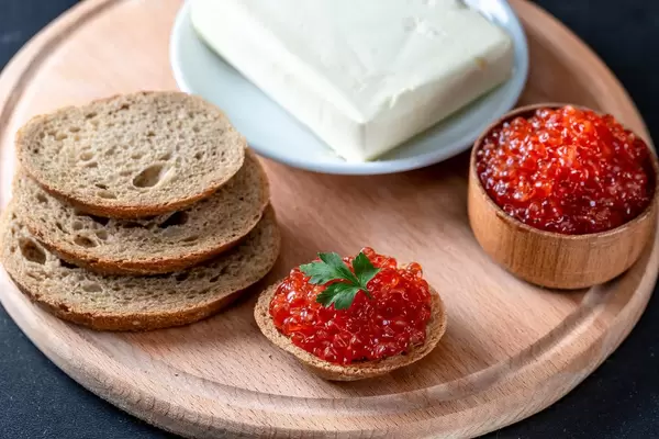 Fresh black bread, butter and red caviar