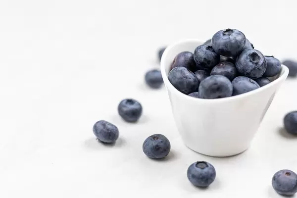 Fresh Blueberries above white background with copy space
