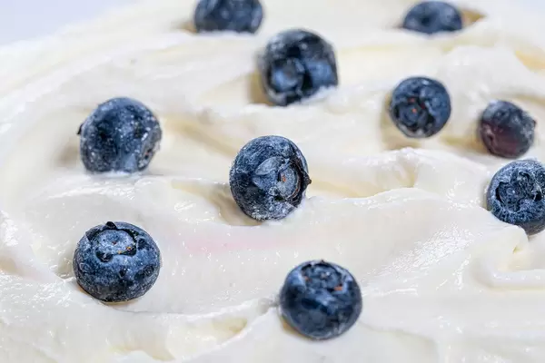 Fresh blueberries on white sweet cream