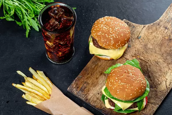 Fresh burgers with cold drink and fries on the black table (Flip 2019)